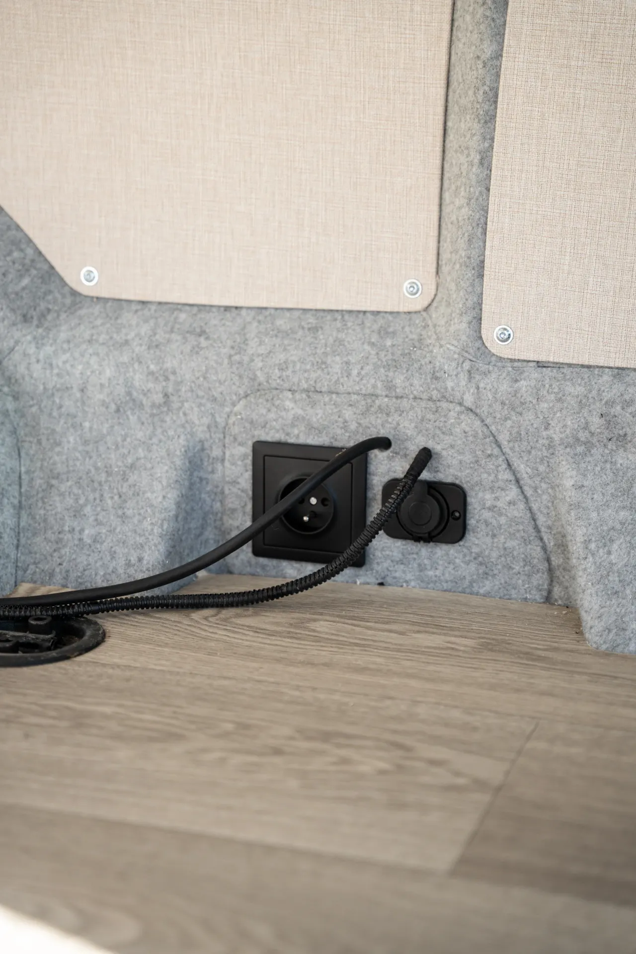 Sockets near the floor beside felt trim