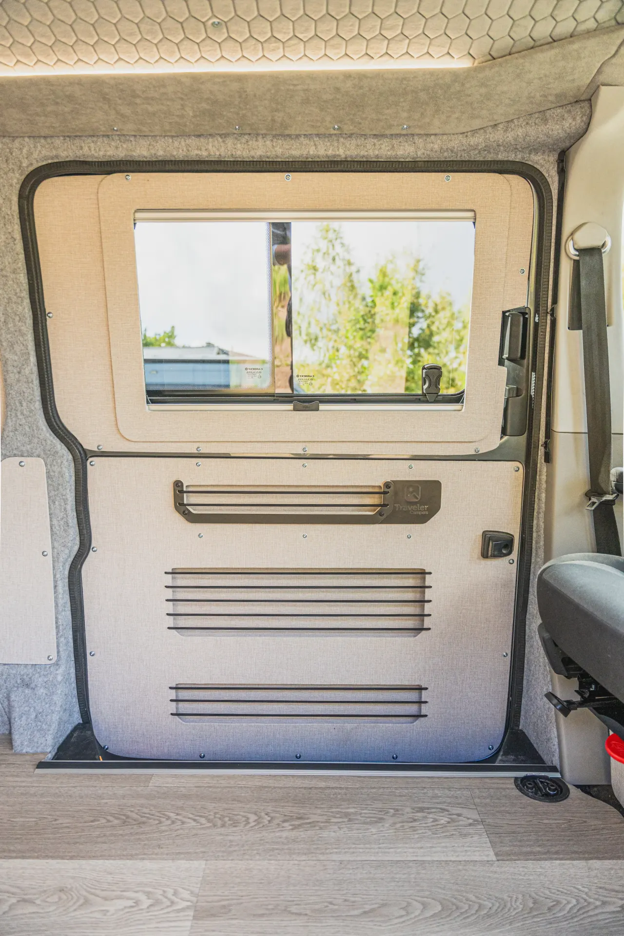 Upholstered door panel with organisers and window
