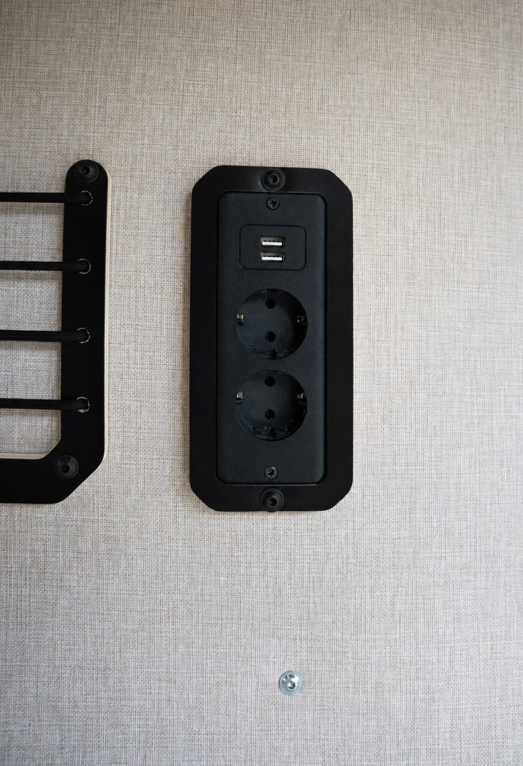 230 V and USB socket panel on the upholstered wall