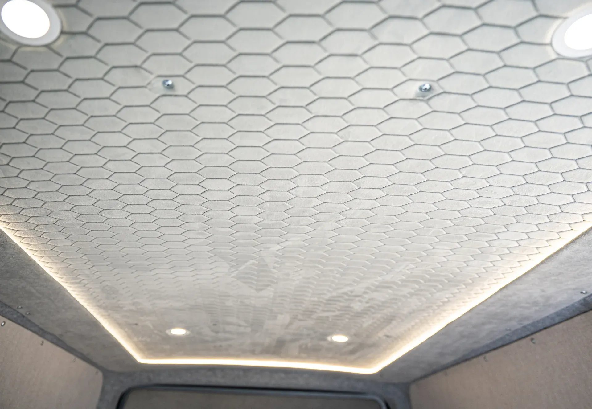 Stitched Alcantara, grey headlining edge and LED spotlights